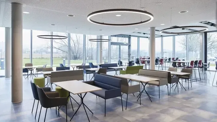 Neben Büroflächen sowie Meeting- und Konferenzräumen beinhaltet das dreistöckige „Center of Climate" auf knapp 5.000 m² auch einen Markenerlebnisraum sowie eine neue Kantine mit Café-Lounge als Begegnungsstätte (links im Bild).